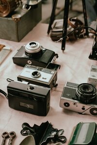 Old film cameras laid out on a table.