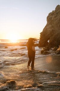 woman stands on beach