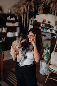 Jaycie, founder of The Jaycie Collective, standing in her luxury salon—showcasing her expertise in creating a high-end, modern client experience.