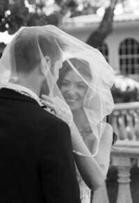 bride smiling at camera with groom underneath veil taken by jacksonville wedding photographer, Shelby Ann Photos