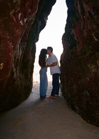 Ashley and Jordan sitting underneath a rose arch on their wedding day in North Port FL.