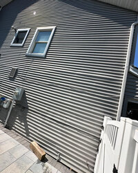 Close-up of clean house siding after pressure washing
