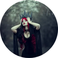 Woman dressed in black placing a crown on her head