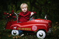 toddler in red firetruck