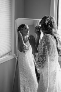 bride putting on earrings