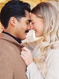 Couple nose to nose during winter Alms Park engagement photos in Cincinnati photographed by Catholic wedding photographers Laura and Matthew