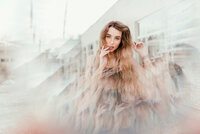A creative self-portrait using prisms and light effects, showcasing experimental photography techniques like double exposure and fine art overlays.