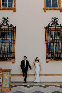 bride and groom holding hands