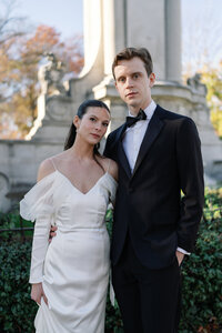 bride and groom in front of stonework