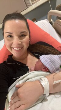 Madison Zeagler with Madison Z Photography postpartum mom in hospital bed holding newborn baby boy