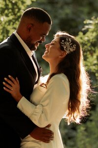 Candid moment couple kissing and gigetting after getting  married at Old Marylebone town hall in London
