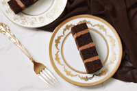 Slice of chocolate truffle cake on a gold plate