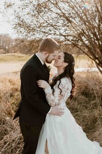 Wedding portrait of couple sharing a warm embrace.