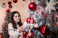 A smiling bride holding a pastel floral bouquet while being embraced by the groom outdoors, captured in a joyful and romantic wedding moment.