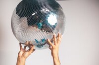 Person holding up a disco ball