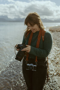 Alaska photographer looking down at her camera