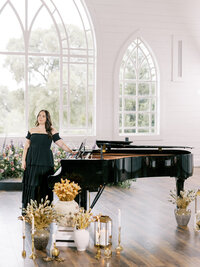 Mikaela Kahn live wedding vocalist standing next to a piano