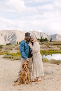 Engagement session at Loveland Pass in Colorado with couple and their golden retriever.
