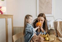Mom unpacking groceries with her daughter. 