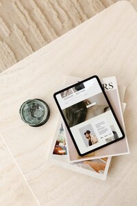 Flatlay lifestyle mockup showing an ipad that features a Showit template from Web Designer Library