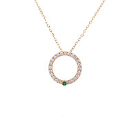 circle pendant set with white diamonds and single emerald in yellow gold
