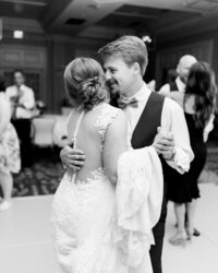 Black and white photo of bride and groom dancing