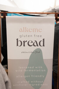 Alkeme Foods brand banner displayed at the Gluten Free Expo, highlighting gluten-free sourdough and clean branding.