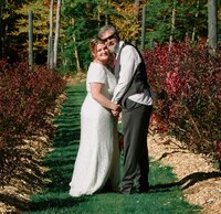 Clients Kristy & Keith  standing  in field at their farm on their wedding day