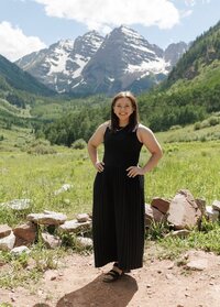 Portrait of Logan Ferree of Mrs. Ferree Photography in front of the Maroon Bells wedding ceremony site in Aspen, Colorado