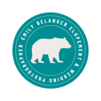 Teal circle badge with a white bear and white font reading "Emily Belanger Elopement & Wedding Photographer" circling picture