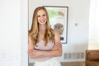 Mary Pernicano, San Diego realtor, standing with arms crossed in a bright home interior, representing trusted guidance for home sellers — Mary Pernicano Real Estate.