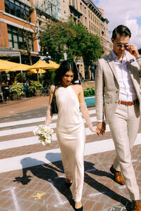 couple sitting on a ledge kelowna rooftop elopement