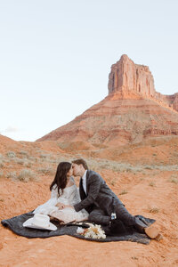 A couple enjoying a picnic at their elopement in Moab