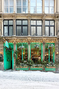 Historic home design in Old Montreal with bright green paint on an aged stone building. Architecture highlights the city’s rich heritage and timeless character.