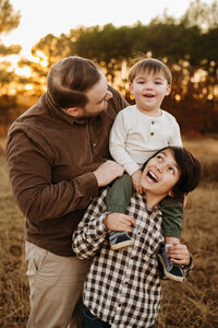 mom holding baby dressed in a boho style for their session with Paula Goforth at Murrell park in flower mound 