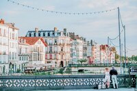 Buildings by river seen from river cruise planned by travel concierge and planning services GG Mack