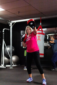 OPWF founder and coach Lori throws a punch, representing her leading Parkinson's exercise classes and boxing. 