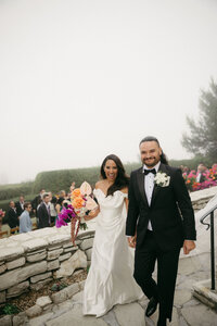 multicultural bride and groom recess from coastal wedding ceremony