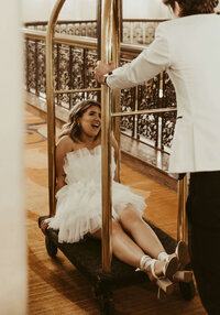 Bride On Luggage Cart Laughing