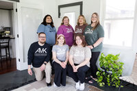 The cleaning crew at AMK cleaning services lined up and smiling after cleaning a clients home.
