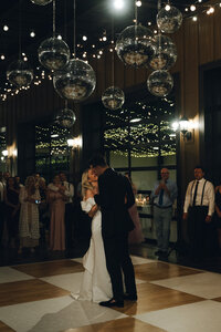 Bride and groom dancing under disco balls at the Estate at Cherokee Dock Venue in Nashville, Tennessee. Photography by Jaimee Raneigh Photography.. 