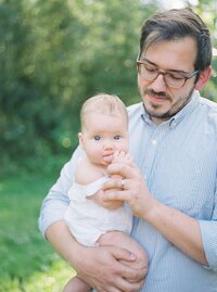 Father holding baby in Washington DC family session.