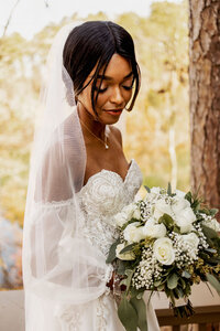 a bride from Lewisville, TX looks at her flowers