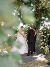 bride and groom kissing at the alter