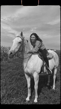 Photographer riding horse back