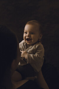 A smiley baby gives her mum a huge smile for their family portrait Moment captured by Eilish Burt Photography in Auckland