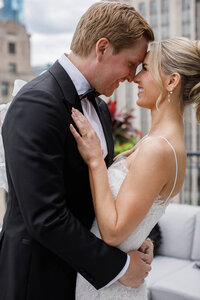 A bride and groom smiling for a closeup photo