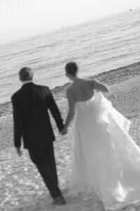 Couple walking towards the ocean