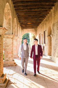 Wedding Photographer in Orange County capturing gay couple hold hands and walk together