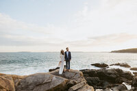 Couple looking out at the water after sunset on their elopement day in Acadia National Park.